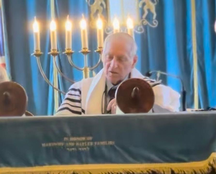 Uri Shoham reading from the torah during Shabbat services